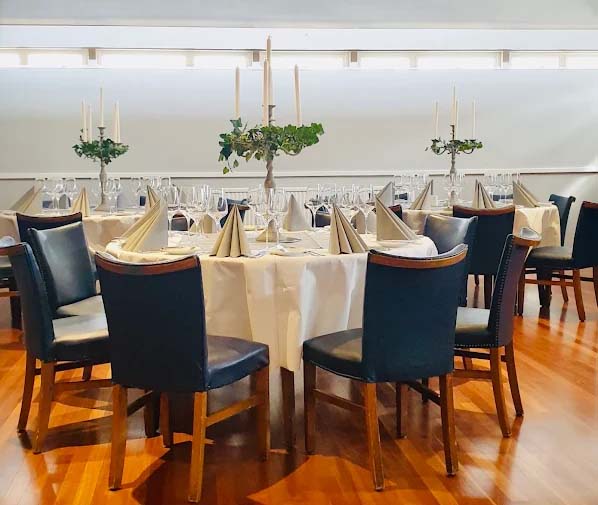 Blue chairs and white table cloths at wedding venue